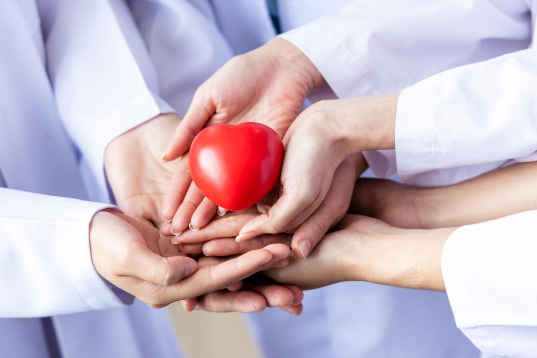 group-of-hands-holding-a-red-heart-hand-of-doctors-donate-and-insurance-insurance-health-care-love-family-insurance-and-csr-concept-free-photo